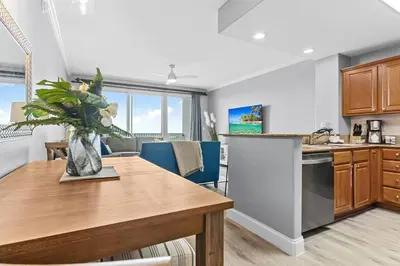 a kitchen and dining room with a wooden table at Cozy Lakeview Condo near Disney in Orlando