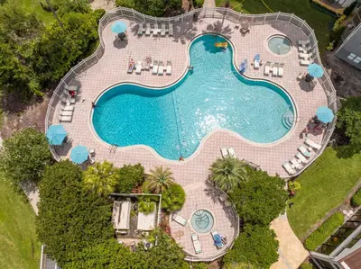 an overhead view of a swimming pool with chairs and a pool at Beautiful Zen Nest 1mile New EPIC Universe in Orlando