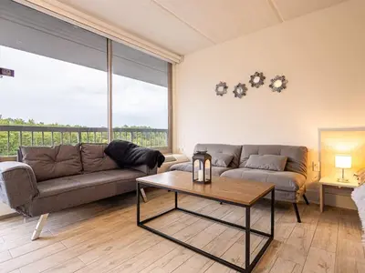 a living room with a couch and a table at Next to Disney 1BR Retreat in Orlando With Lake view in Kissimmee