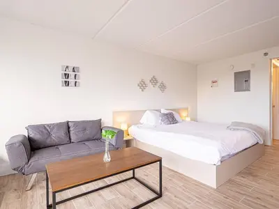 a bedroom with a bed and a couch and a table at Spacious 1BR Condo in Orlando and 5 minutes to Disney in Kissimmee