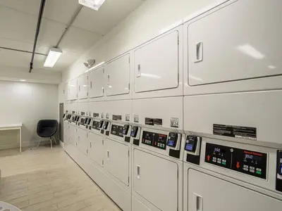 a room with a row of machines at Spacious 1BR Condo in Orlando and 5 minutes to Disney in Kissimmee