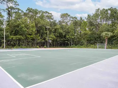 a tennis court with a net on it at Spacious 1BR Condo in Orlando and 5 minutes to Disney in Kissimmee