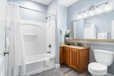a bathroom with a toilet and a sink and a shower at 5-Min to Disney Lakeside Retreat in Orlando