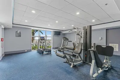a gym with cardio equipment in a hotel room at 5-Min to Disney Lakeside Retreat in Orlando