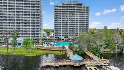 a resort with a pool and two tall buildings at 5-Min to Disney Lakeside Retreat in Orlando