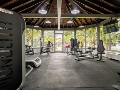 a gym with several treadmills and chairs in a room at Vacation 1BR Rental in Orlando & minutes to Disney in Kissimmee