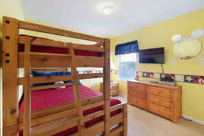 a bedroom with two bunk beds and a television at Private Pool, Spa, Game Room & Theme Park Magic in Kissimmee