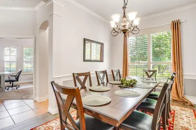 a dining room with a wooden table and chairs at Community Amenities at Spacious Orlando Home! in Orlando