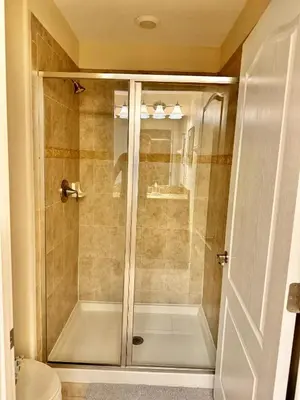 a shower with a glass door in a bathroom at Orlando Area Vacation Rental with private pool in Kissimmee
