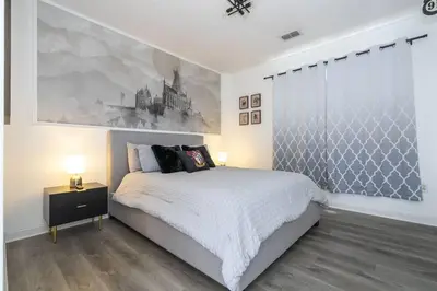 a bedroom with a bed and a painting on the wall at A Magical condo close to Disney CSS1 in Kissimmee