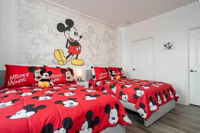 a bedroom with two beds and a mickey mouse bedspread at A Magical condo close to Disney CSS1 in Kissimmee