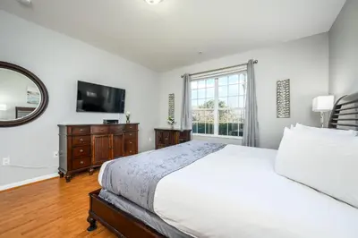 a bedroom with a bed and a mirror and a television at Luxury Lakeview, Vista Cay Orlando 1027 in Orlando