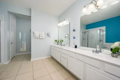 a bathroom with two sinks and a large mirror at Luxury Lakeview, Vista Cay Orlando 1027 in Orlando