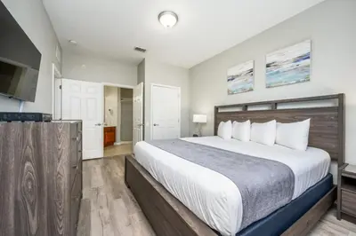 a bedroom with a large bed and a television at Epic Universe New Listing Beautiful Vacation Condo - 3018 in Orlando