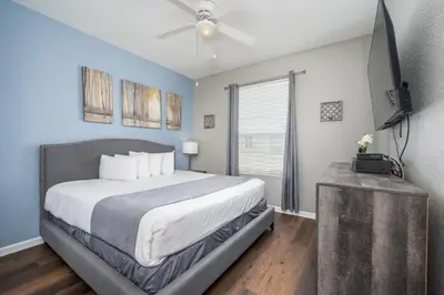 a bedroom with a bed and a ceiling fan at Beautiful Deluxe Condo, Vista Cay - 3024 in Orlando