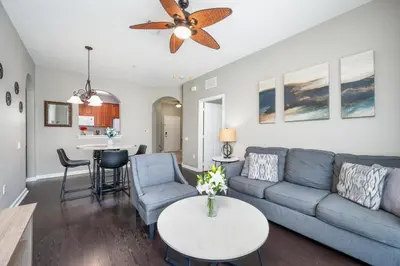 a living room with a couch and a table at Beautiful Deluxe Condo, Vista Cay - 3024 in Orlando