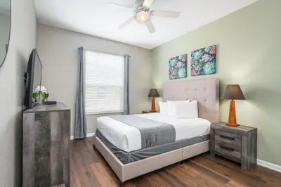 a bedroom with a bed and a ceiling fan at Beautiful Deluxe Condo, Vista Cay - 3024 in Orlando