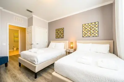 two beds in a room with two beds sidx sidx sidx sidx at Epic Universe New Deluxe Condo, Vista Cay - 3022 in Orlando