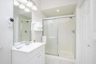 a white bathroom with a shower and a sink at Epic Universe New Listing, Family Vacation Townhome - 4011 in Orlando