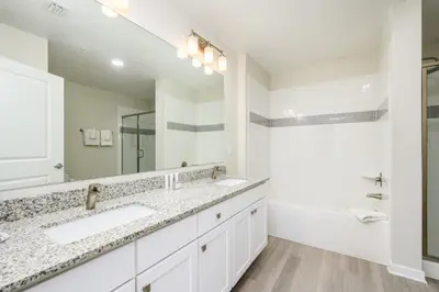 a bathroom with two sinks and a large mirror at New Modern Vista Cay Reserve Condo - 6003 in Orlando