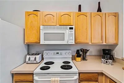 a kitchen with a stove and a microwave at 2533 Renshaw Street in Orlando