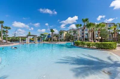a large swimming pool at a resort with palm trees at 2533 Renshaw Street in Orlando