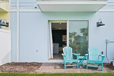 two blue chairs sitting on a patio next to a house at 3148 Caribbean Soul Drive in Orlando