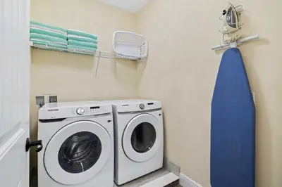 a laundry room with a washing machine and a blue towel at 3148 Caribbean Soul Drive in Orlando