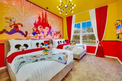a bedroom with two beds and a disney mural at 3BD 3BA Themed House Near Disney in Orlando