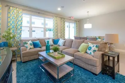 a living room with a couch and a table at Pool Private tub BBQ Mins to Disney and Universal in Kissimmee