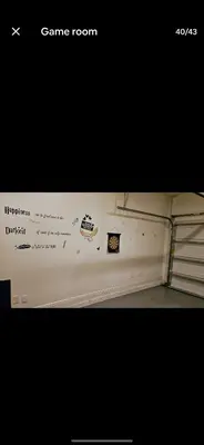 a room with a white wall with stickers on it at Pool Private tub BBQ Mins to Disney and Universal in Kissimmee