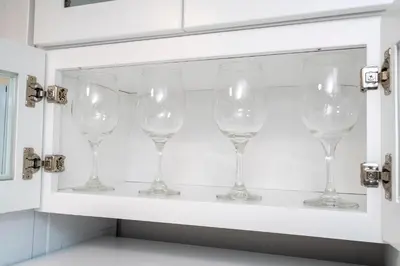 a row of wine glasses on a shelf at Cozy apt 2 bedrooms 1 mile Universal Studios in Orlando