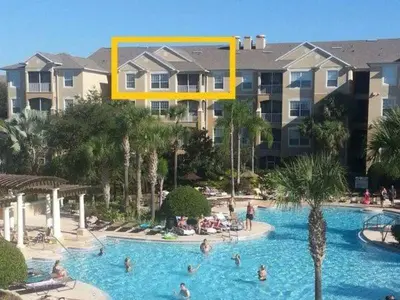 a large swimming pool with people in a resort at POOL VIEW 3 Bedroom Condo at Windsor Hills 'The Lido Deck' in Orlando