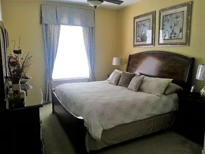 a bedroom with a large bed and a window at POOL VIEW 3 Bedroom Condo at Windsor Hills 'The Lido Deck' in Orlando