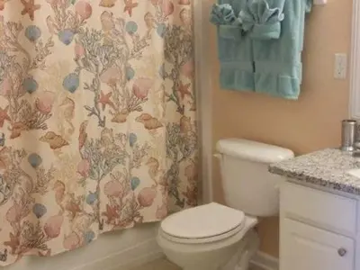 a bathroom with a toilet and a shower curtain at POOL VIEW 3 Bedroom Condo at Windsor Hills 'The Lido Deck' in Orlando
