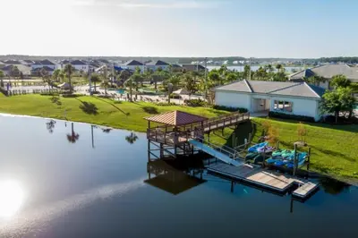 an aerial view of a house with a dock on the water at 2 Bedrooms 2 Bathrooms Storey Lake Ct in Kissimmee