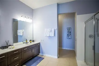 a large bathroom with a sink and a shower at The Epic Boca Penthouse Vista Cay Orlando in Orlando
