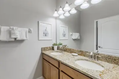 a bathroom with two sinks and a large mirror at Palms of Paradise! in Kissimmee