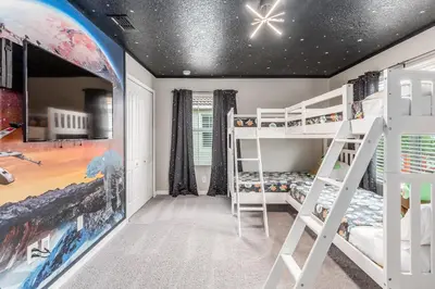 a bedroom with two bunk beds and a star ceiling at Palms of Paradise! in Kissimmee