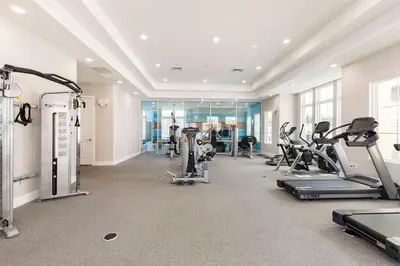 a gym with treadmills and cardio equipment in a building at Cozy Beautiful 5 Suites close to Disney World in Orlando