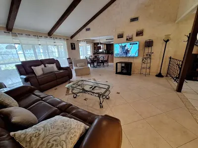 a living room with leather couches and a tv at 3 Bed 2 Bath amazing Lakeview , Jacuzzi Bath Tub in Oviedo