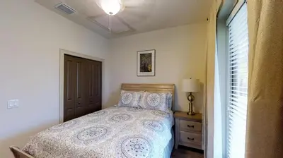 a bedroom with a bed and a lamp and a window at Quiet 2 Bed Cottage in Oviedo w Resort Discounts in Oviedo