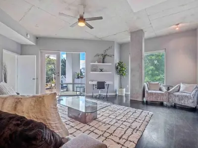 a living room with a couch and a glass table at Lovely 2Bdrm 2Bath Thorton Park Condo with secure parking in Orlando