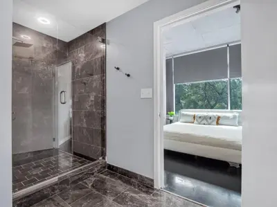 a bedroom with a bed and a large window at Lovely 2Bdrm 2Bath Thorton Park Condo with secure parking in Orlando