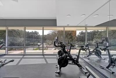 a gym with several exercise bikes in front of a building at Lovely 2Bdrm 2Bath Thorton Park Condo with secure parking in Orlando