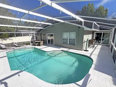 a swimming pool on the patio of a house at Stardust Villa home in Kissimmee