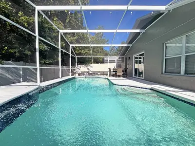 a swimming pool in the backyard of a house at Stardust Villa home in Kissimmee