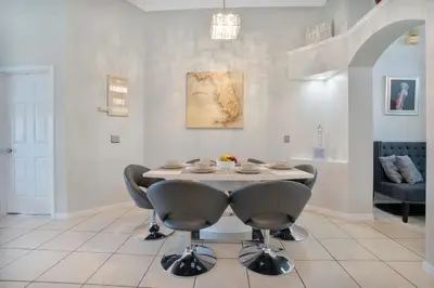 a dining room with a table and chairs at Stunning Home Near Disney World in Orlando