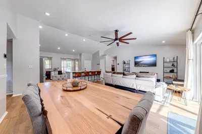 a living room with a wooden table and a couch at Beautiful home, centrally located to Parks with Pool in Orlando
