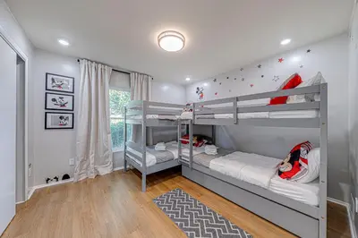 a bedroom with two bunk beds in a room at Beautiful home, centrally located to Parks with Pool in Orlando